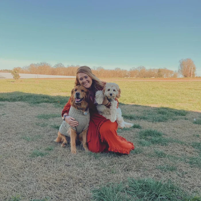 CHLOE K. smiling with dogs